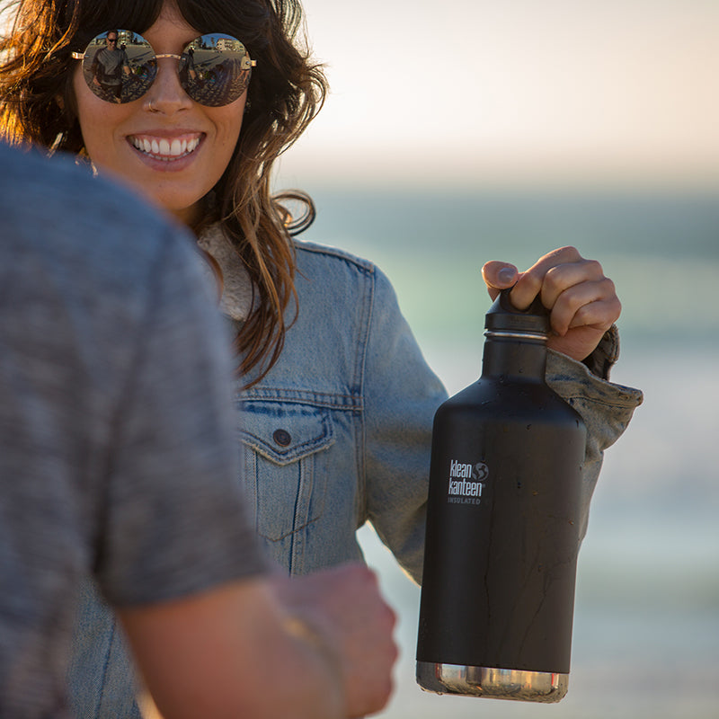 64oz-classic-with-loop-cap-i6 64oz_insulated_classic_black_beach_girl_hand_square.jpg